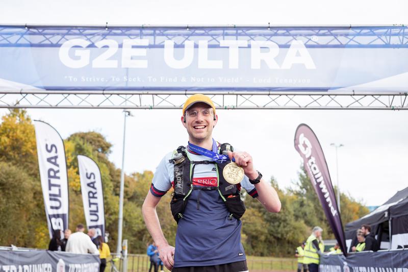 Celebrating with my medal at the finish. Credit: Ridgeline media and GB Ultras