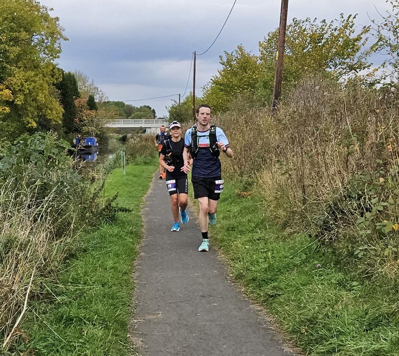 Me running along the canal path with a lady running close behind. Credit: Derek Marshall