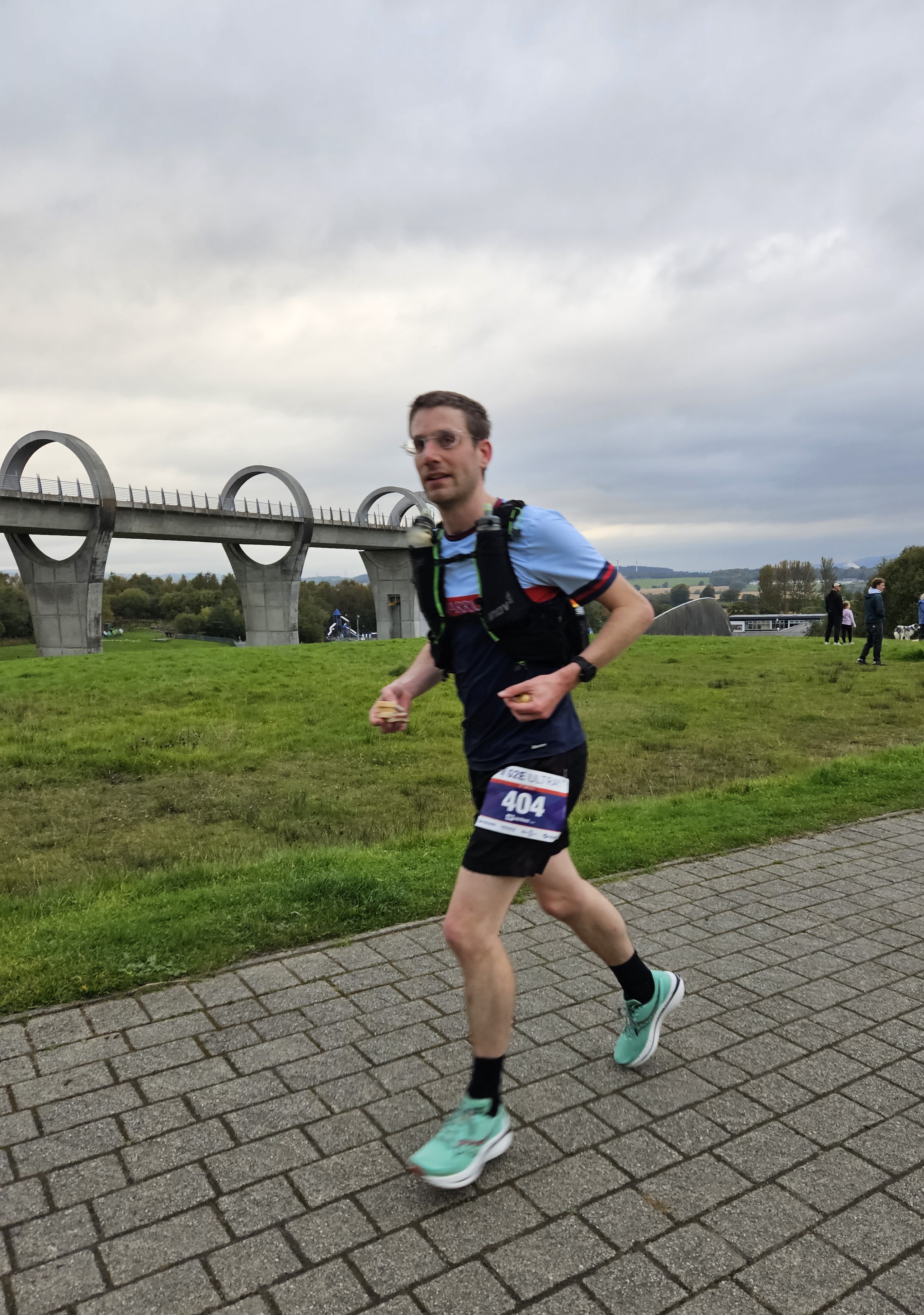 Passing the Falkirk Wheel Me running up a steep hill with the Falkirk Wheel in the background. Credit: Derek Marshall